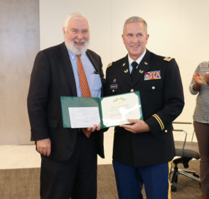 Lieutenant Colonel Edward O'Sheehan (right) presents the Governor's Florida Commendation Medal to Miami partner Steve Maher. 