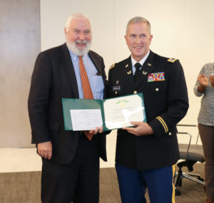 Lieutenant Colonel Edward O'Sheehan (right) presents the Governor's Florida Commendation Medal to Miami partner Steve Maher.